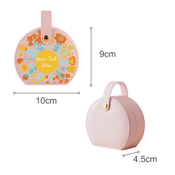 A small portable pink PU leather jewellery box with a floral design and a handle, measuring 9cm by 10cm.