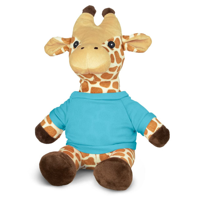 A plush giraffe toy with brown and cream spots, wearing a blue shirt, sitting upright. It has a friendly expression and a small logo.