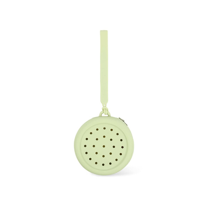 A round silicone pouch in a soft green colour with perforated holes and a strap for easy carrying.