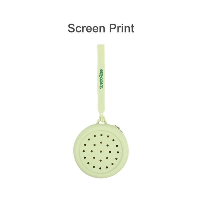 A round, pale green silicone pouch with holes, featuring a loop handle and a logo.