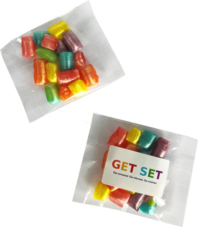 A packet of colourful humbugs in various shades, including pink, yellow, green, and blue, with packaging and branding.