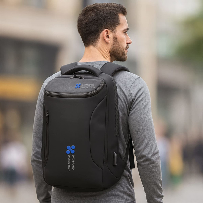 A black waterproof business backpack worn by a person in a casual outfit, featuring a logo on the front.