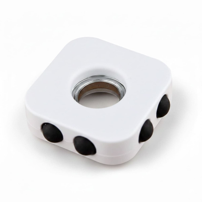 A white decompression finger spinner with three black buttons and a central bearing. It has a smooth, square design.