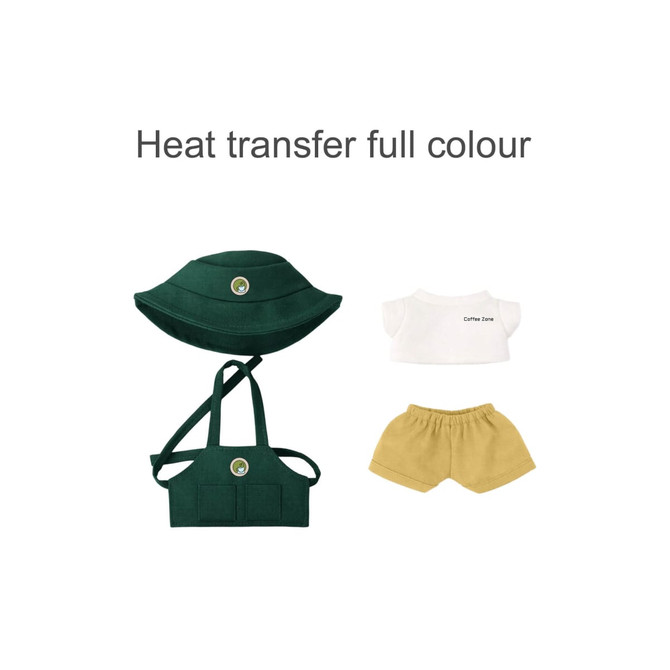 A green hat, white top with text, and mustard shorts for a 15–17cm doll, featuring a logo.