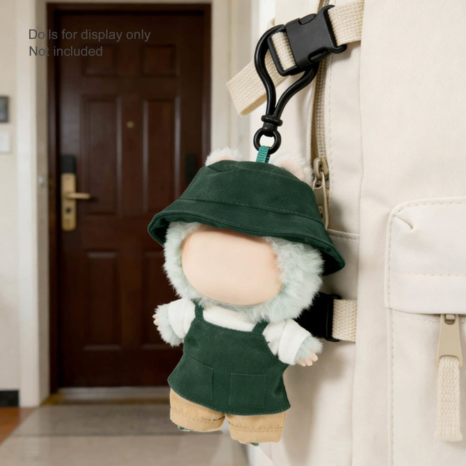 A green plush doll with a hat and overalls, attached to a backpack. Soft and cuddly design.