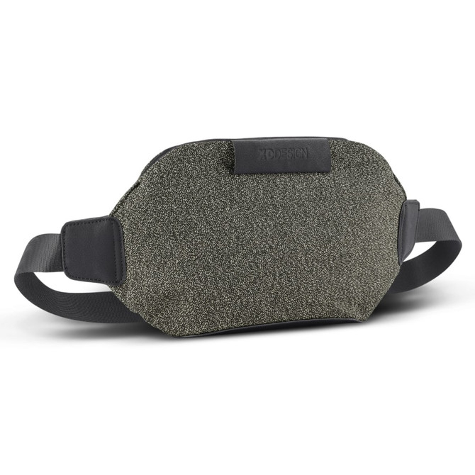 A grey-green Urban Belt Bag with black straps and a branded logo. The material has a textured finish.