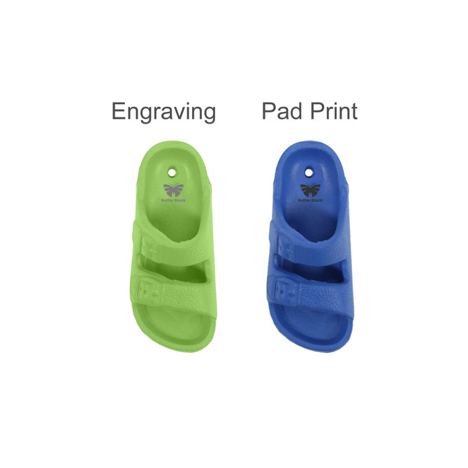 A green and a blue fridge magnet shaped like a slide, each with a branding logo.