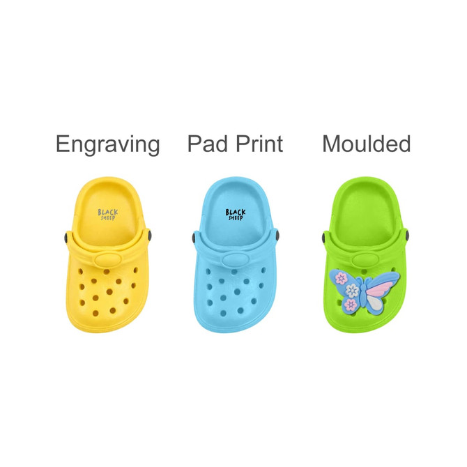 A trio of classic clog shoe fridge magnets in yellow, blue, and green, featuring different designs and branding.