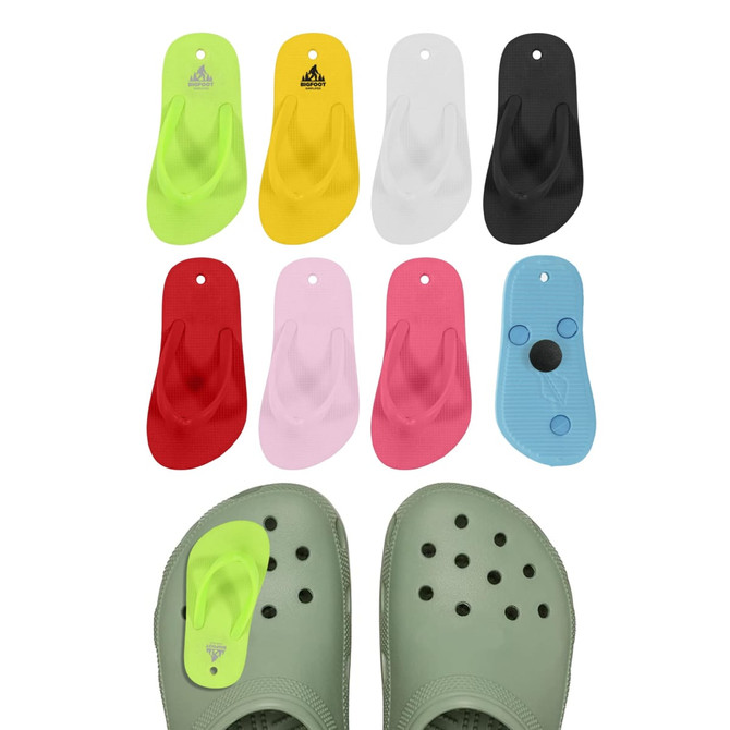 Colourful thong-shaped clog shoe charms in lime green, yellow, red, pink, white, black, and blue, arranged with a pair of green clogs.