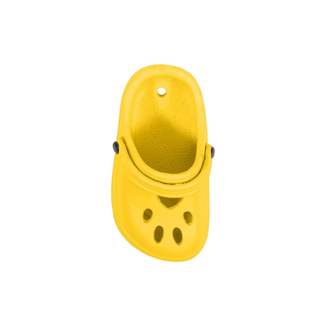 A bright yellow clog shoe charm with ventilation holes and a rounded shape, featuring a black button detail.