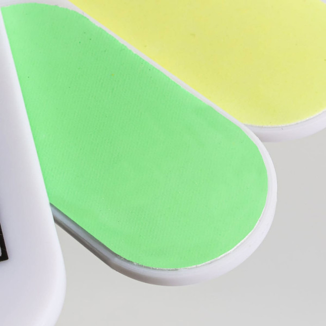 A foldable nail file block featuring green and yellow filing surfaces with a handle. It has a logo on the side.