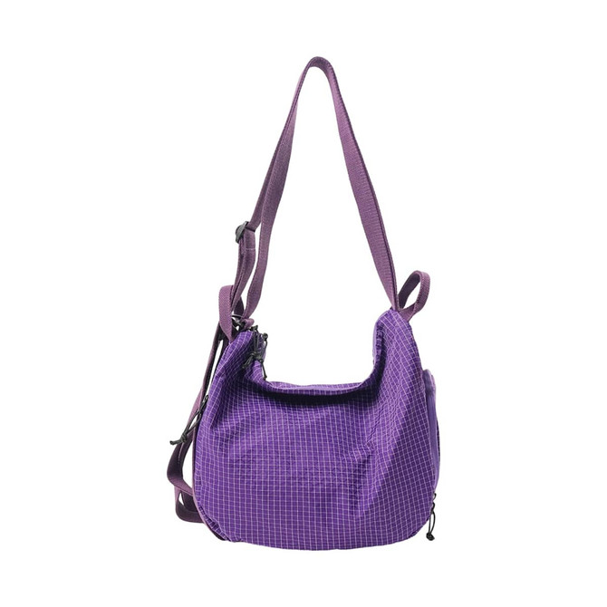 A purple convertible lightweight backpack duffel bag with an adjustable strap and zippered compartments.
