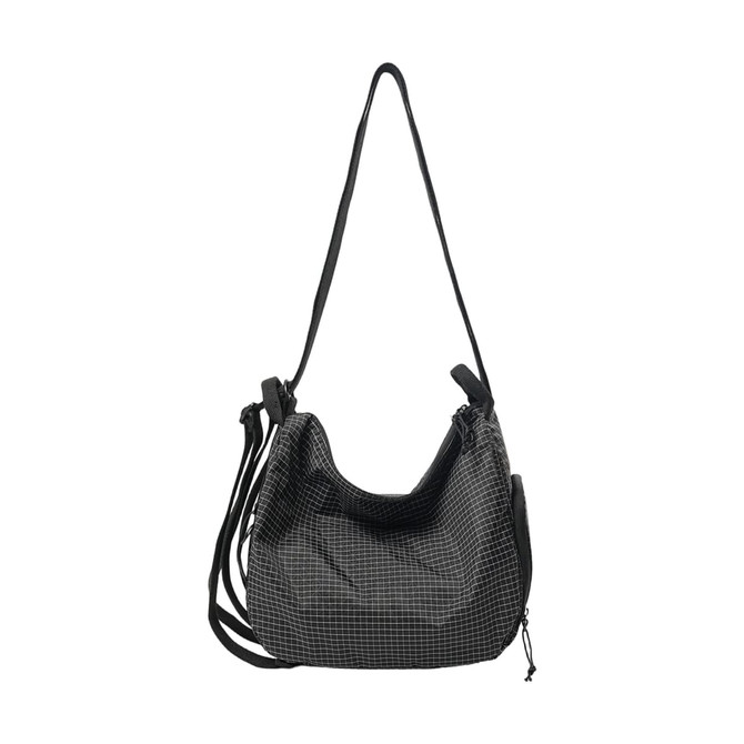 A convertible lightweight backpack duffel bag in black with a grid pattern and multiple straps.