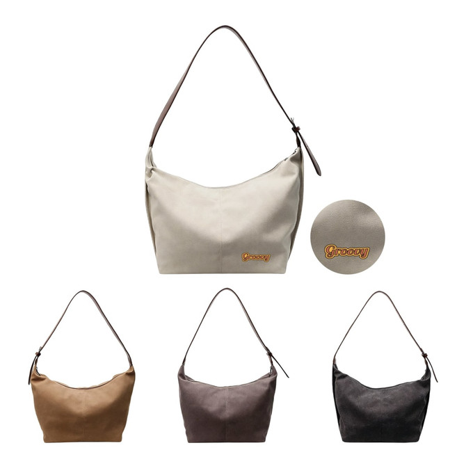 A canvas tote bag in cream, brown, grey, and black, featuring a logo. It has a shoulder strap for easy carrying.