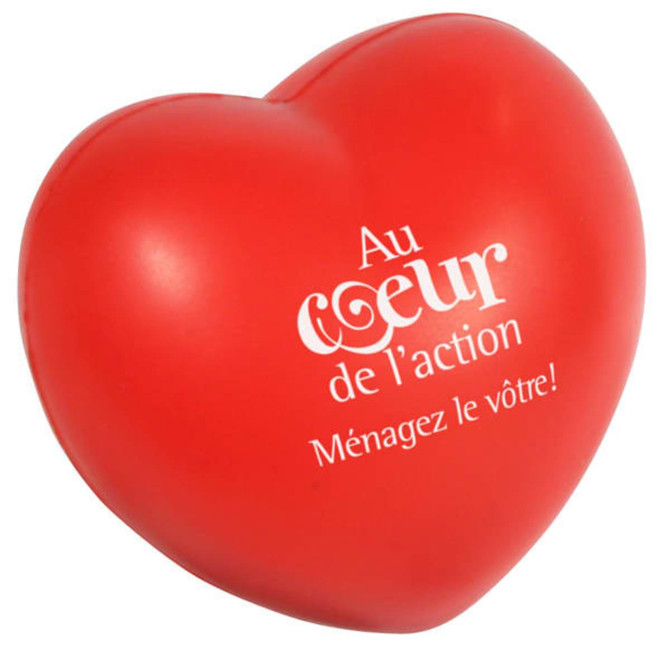 A large red heart-shaped stress reliever with a logo on the front.