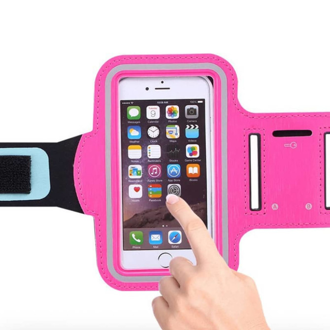 A pink cell phone arm band with a transparent pocket for a phone and adjustable strap. It features a logo.