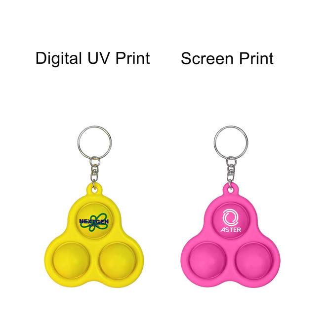 A yellow and a pink keychain featuring three bubble buttons and a logo on each, attached to a metal keyring.