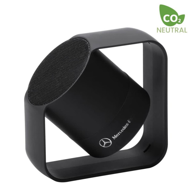 A black wireless speaker with a circular top, enclosed in a square frame, featuring a logo.