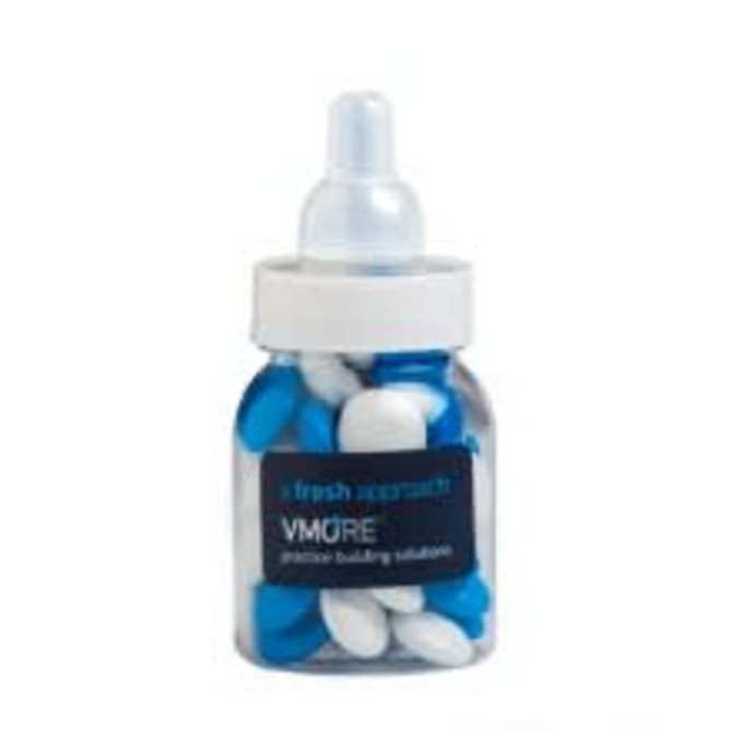 A drink bottle filled with blue and white choc beans, featuring a white lid and base. The bottle has a logo.
