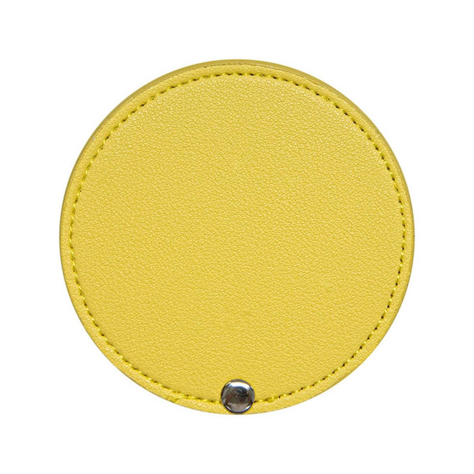 A round makeup mirror in bright yellow with a textured finish and a silver snap button.