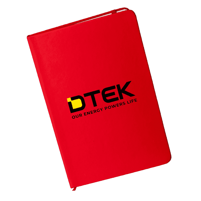A red A5 notebook with a logo on the cover. The notebook has a smooth finish and is closed.