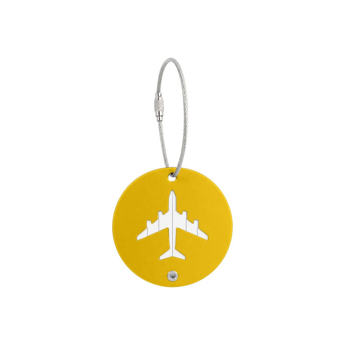 A yellow round luggage tag featuring a cut-out airplane design, secured with a metal wire cable.