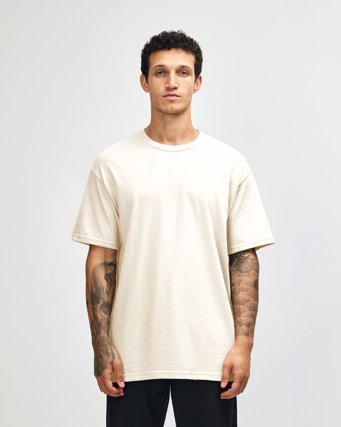 A heavyweight cotton unisex T-shirt in a light cream colour, featuring a standard crew neck and short sleeves.