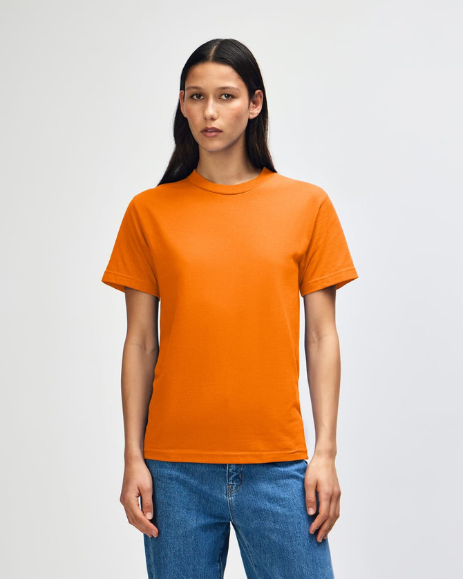 An orange heavyweight cotton unisex T-shirt is displayed, featuring a simple design and a logo.