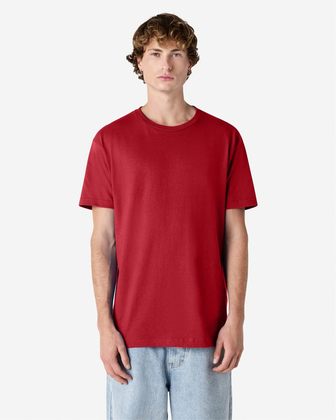A unisex heavyweight cotton T-shirt in red, featuring a simple design and a relaxed fit.