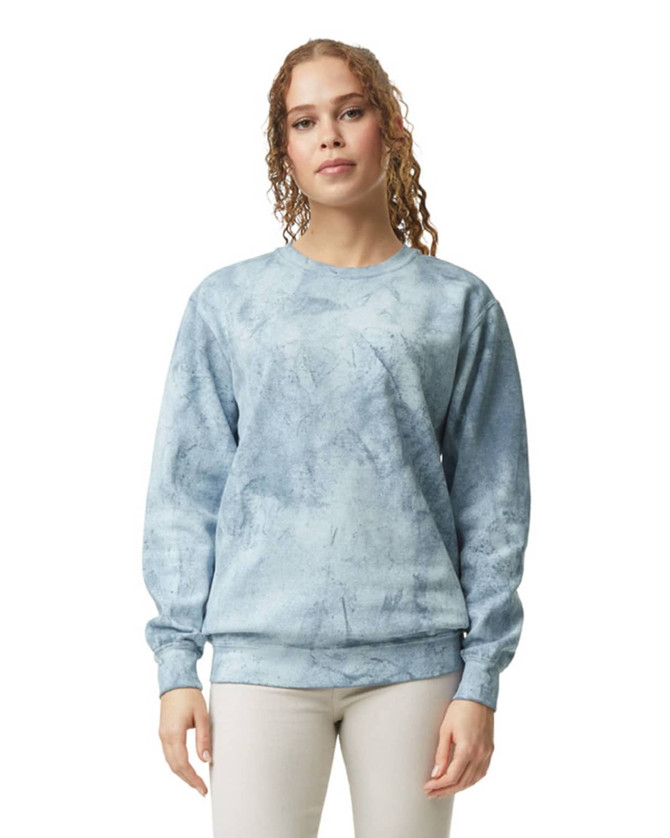 A crewneck sweatshirt in a light blue tie-dye pattern, featuring long sleeves and a logo.