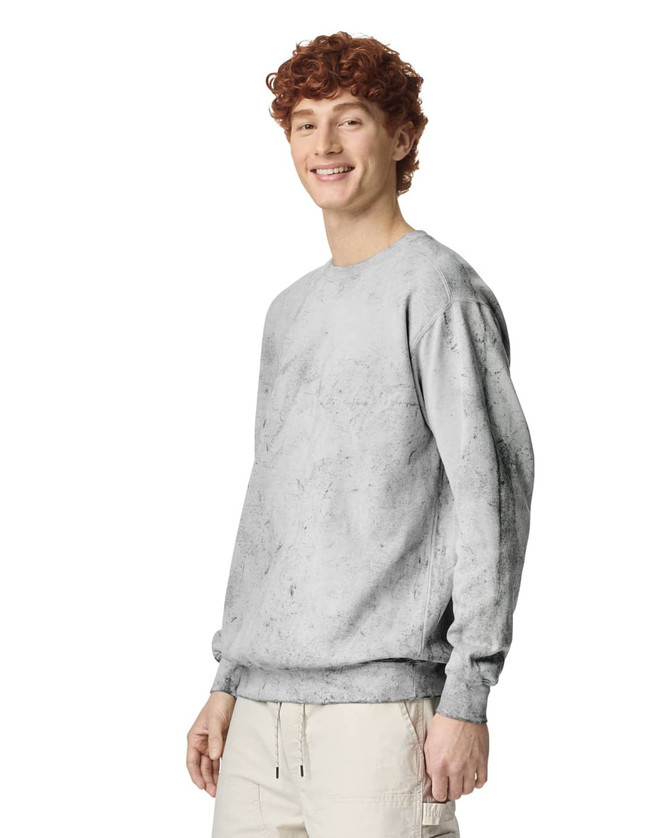 A light grey crewneck sweatshirt featuring a relaxed fit and a logo, showcased on a model.
