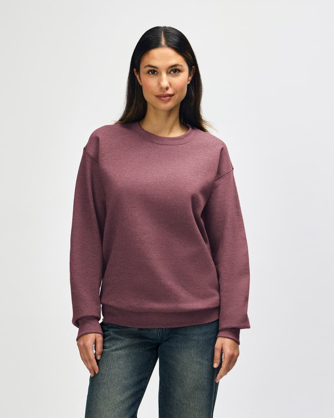 A maroon Gildan Heavy Blend adult crewneck sweatshirt with long sleeves and a relaxed fit. It features a logo.