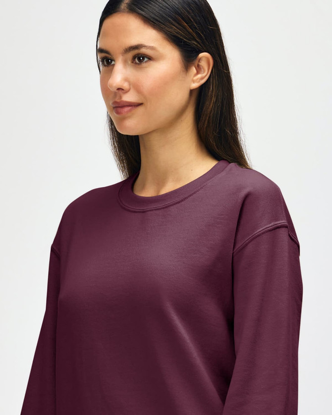 A maroon Gildan Heavy Blend adult crewneck sweatshirt with a logo, featuring a relaxed fit and long sleeves.