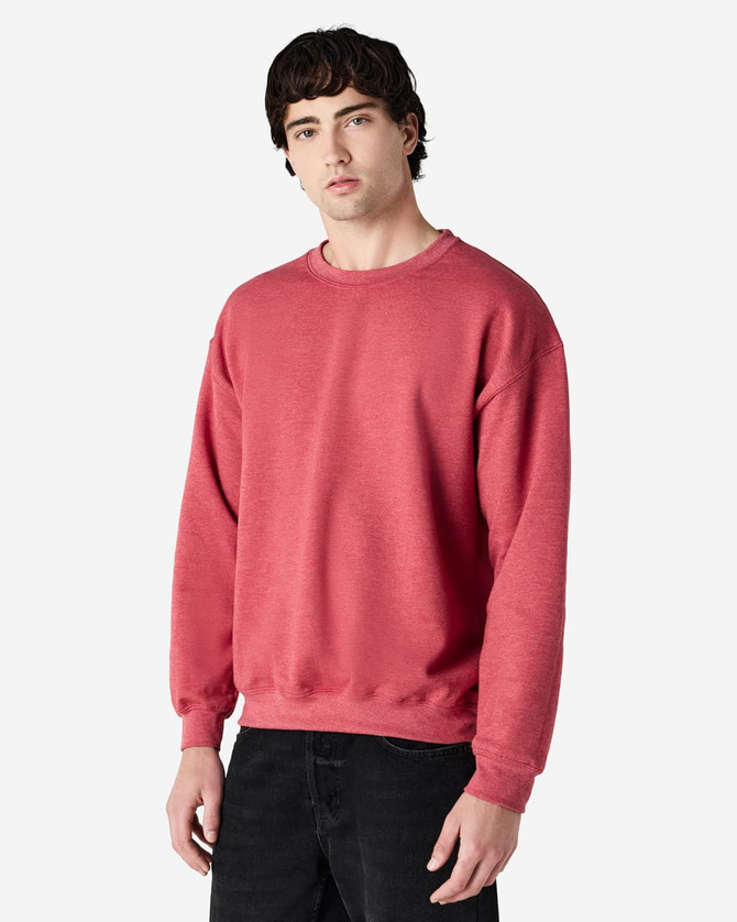 A red Gildan Heavy Blend adult crewneck sweatshirt displayed on a model, featuring long sleeves and a relaxed fit.