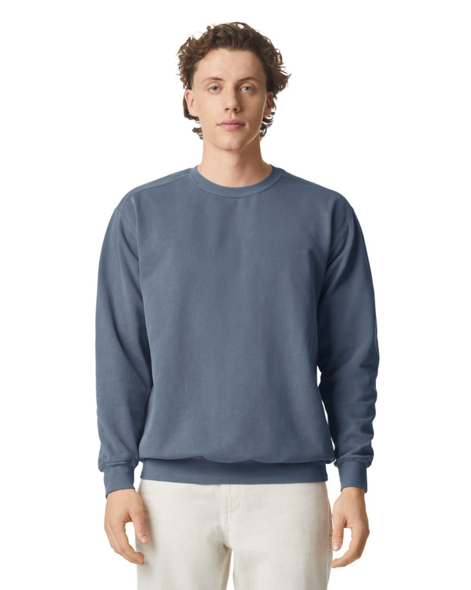 A blue adult crewneck sweatshirt with long sleeves and a plain design. Features a logo on one side.