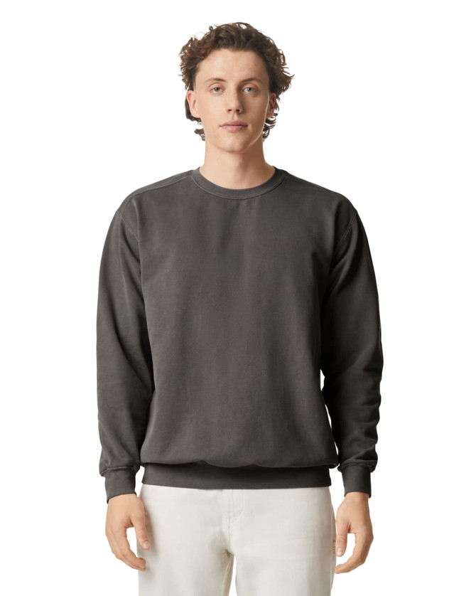 A crewneck sweatshirt in a dark grey colour, featuring a simple design and a logo on the front.