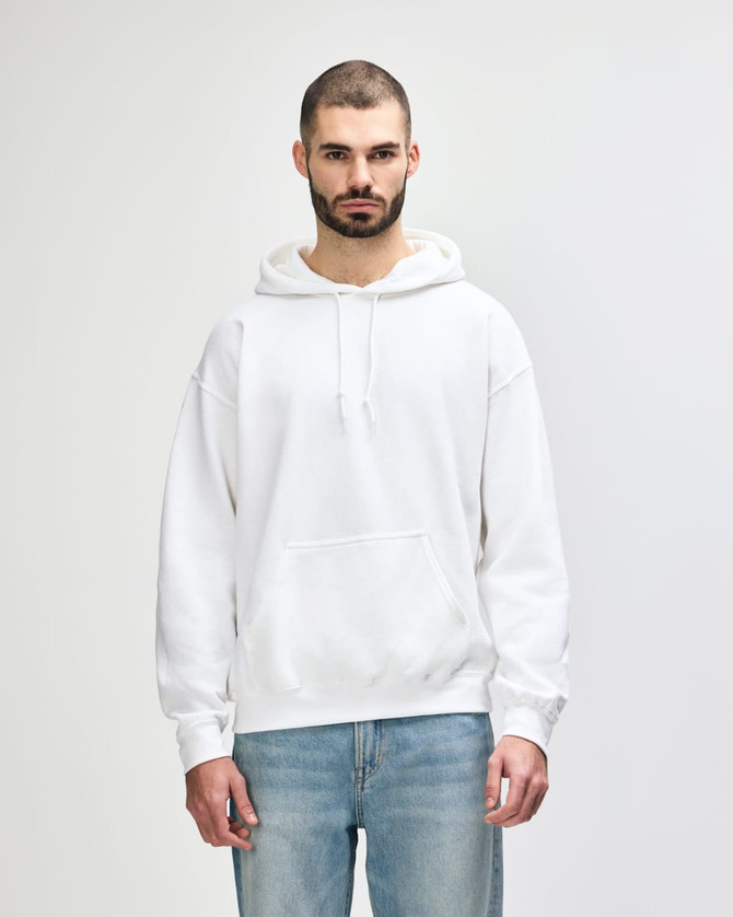 A white hooded sweatshirt with a front pocket and drawstrings, displayed on a model against a plain background.