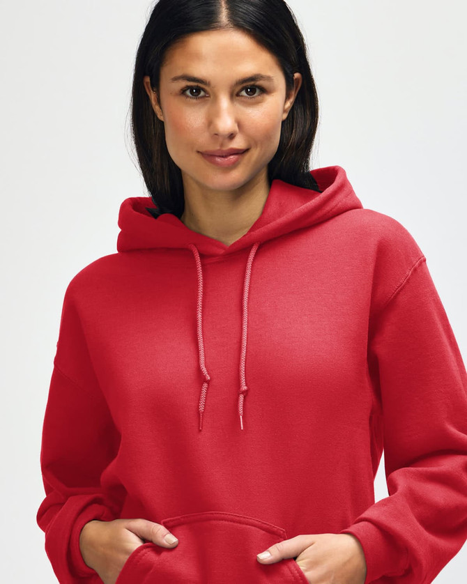 A red Gildan Heavy Blend adult hooded sweatshirt worn by a model, featuring a hood and drawstrings.