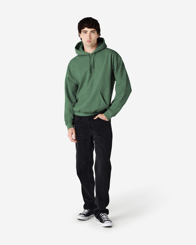A green hooded sweatshirt worn by a model, paired with black jeans and sneakers, featuring a logo.