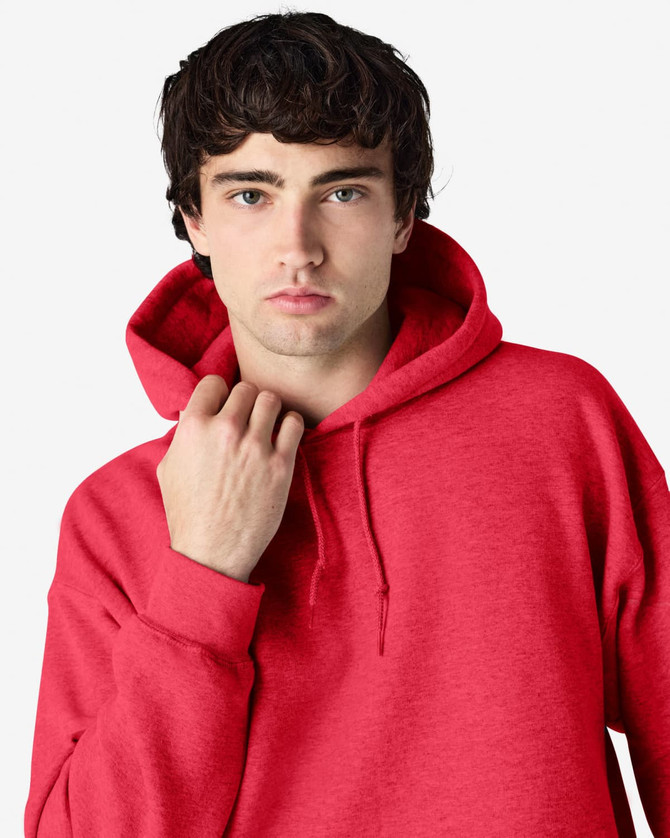 A red hooded sweatshirt featuring a front pocket and a hood, worn by a model with dark hair.