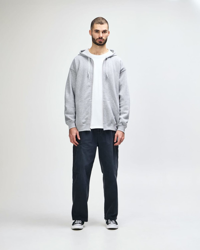 A grey full zip hooded sweatshirt featuring a front pocket and a hood. It has a logo on the side.