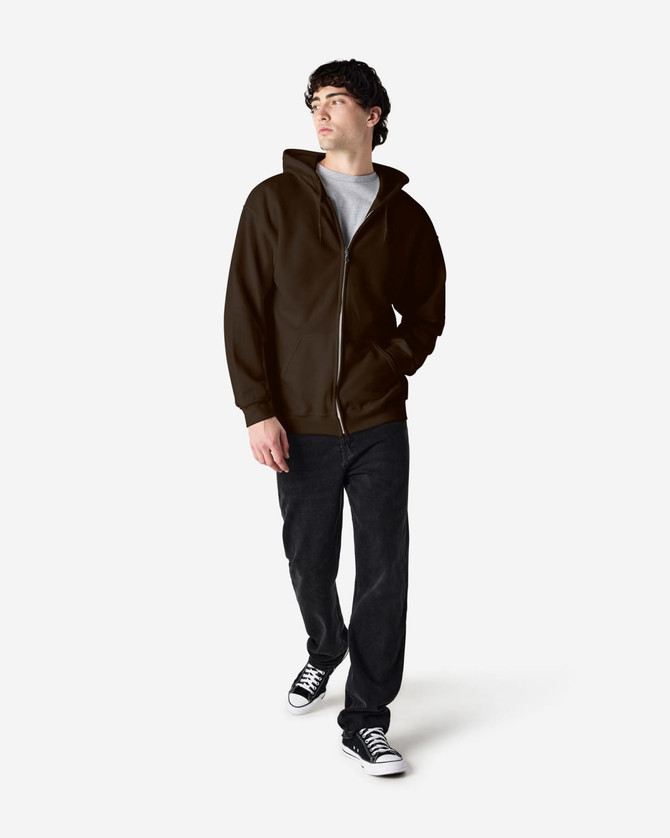 A model wears a brown Gildan Heavy Blend full zip hooded sweatshirt with a grey t-shirt and black pants.