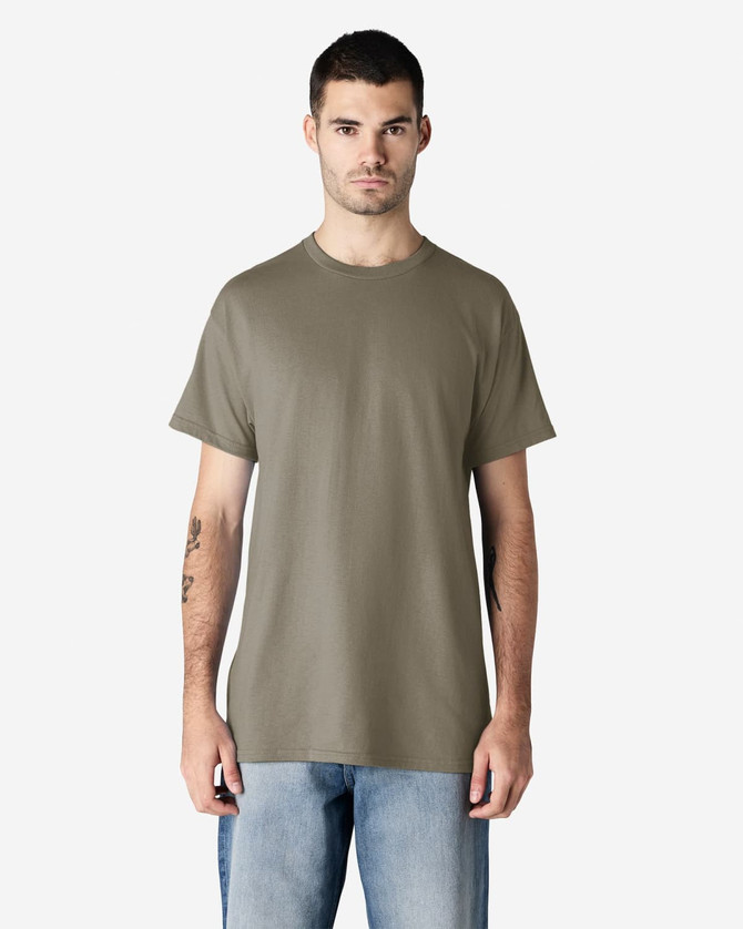 A man is wearing a khaki Gildan Ultra Cotton adult T-shirt, paired with light blue jeans. The shirt has a logo.