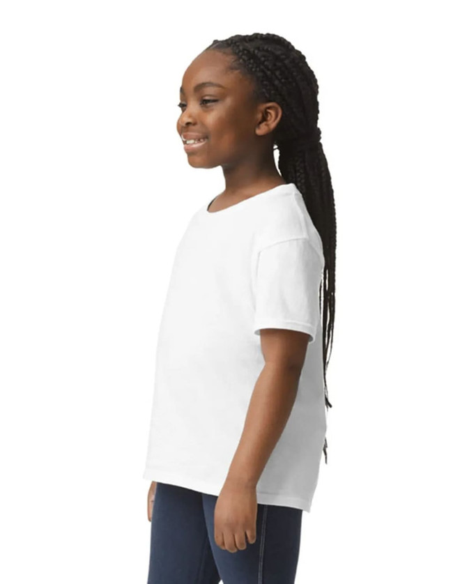 A white youth short sleeve T-shirt is displayed on a smiling child with long braids, set against a plain background.