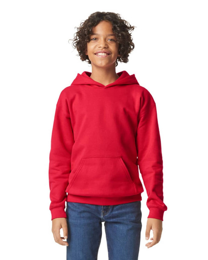 A red youth hooded sweatshirt with a front pocket, featuring a logo. Model is smiling and wearing jeans.