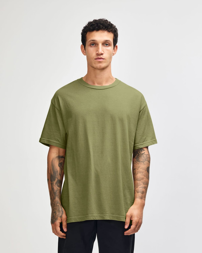 A unisex heavyweight cotton t-shirt in olive green, featuring a relaxed fit and short sleeves. It includes a logo.