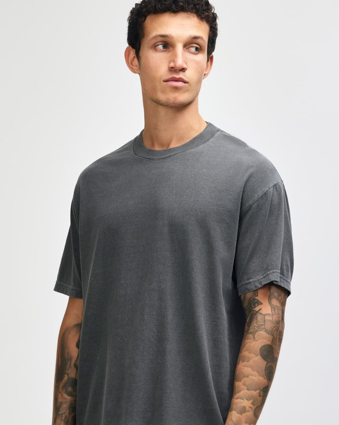 A grey unisex garment-dyed heavyweight cotton T-shirt with a relaxed fit and short sleeves, featuring a logo.
