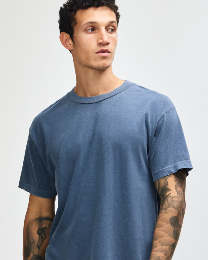 A unisex heavyweight cotton T-shirt in navy, featuring a classic crew neck and short sleeves. It has a logo.