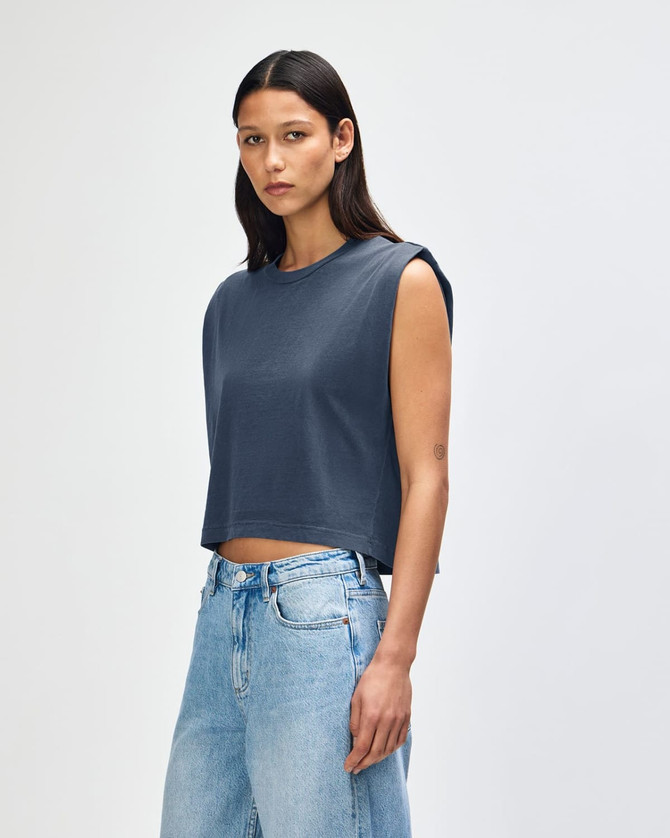 A sleeveless, cropped muscle t-shirt in deep blue, featuring a simple design and a logo.