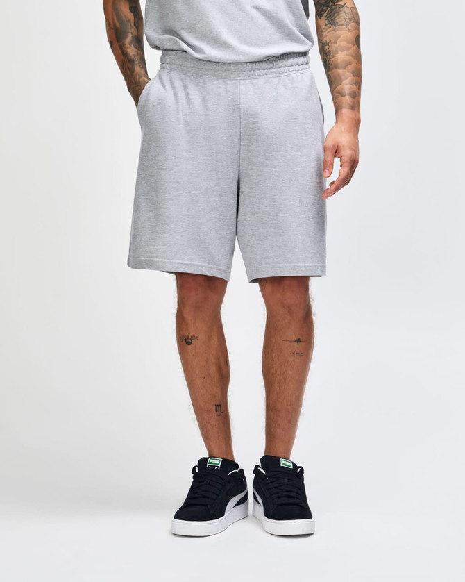 Grey unisex gym shorts with an elastic waistband, featuring a logo on the side. Suitable for sports and casual wear.